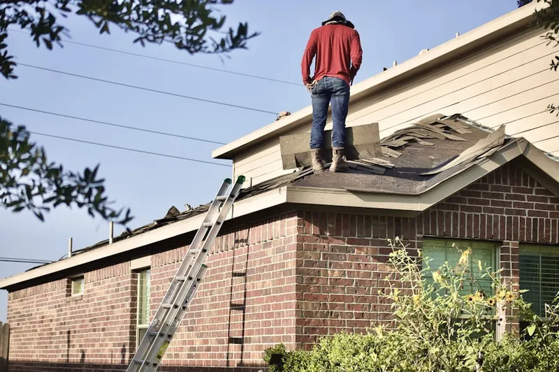Professional roofer working on a residential roof in East Ocean Avenue